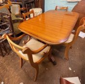 A yew wood extending dining table with two carvers and four dining chairs, W150cm H79cm D95cm
