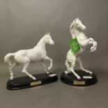 Two Royal Doulton matt white 'Spirit Horses' raised on black wooden bases, Spirit of the Wild and