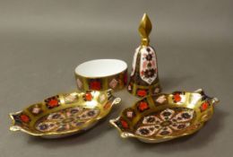 Two Royal Crown Derby shaped pin dishes, together with a matching candle snuffer and small oval pot,
