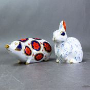 Royal Crown Derby Snowy Rabbit paperweight, gold stopper, together with a Pig paperweight with