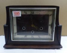 Oak cased late Art Deco period mantle clock, pendulum present, W 30cm.