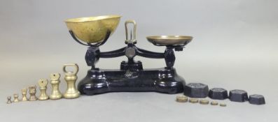 A set of Libra Scale Co balance scales with brass bell weights and hexagonal cast iron calibration