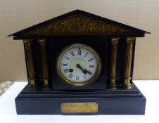 Late Victorian four pillar black slate mantle clock, with pendulum to the interior, W 35cm.