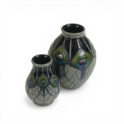 Moorcroft vase decorated in the Peacock parade design, dated 2012 and a similar smaller version,
