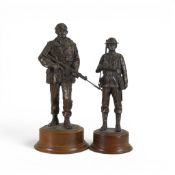 Two collectible cold-bronze resin sculptures including British Army soldier's, on circular wooden