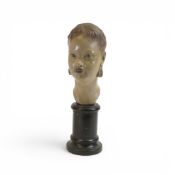 Mid-century plaster bust depicting a young woman, on a wooden plinth, marked Reg-887566 o the back