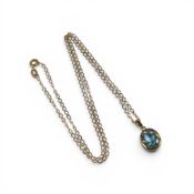 9ct gold oval blue stone pendant & chain, 2.8g.