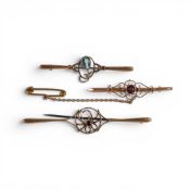 Three antique 9ct gold bar broches, each set with various coloured gem stones, each with steel