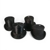 A collection of late 19th/early 20th century black top hats, made from silk plush or fur felt. (4)