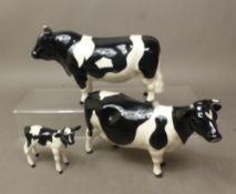 Beswick Fresian cattle family, including Champion Claybury Leegwater cow, Champion Coddington Hilt