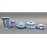 Wedgwood blue jasperware to include lidded trinket boxes, small urn-shaped vase and trumpet footed