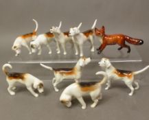 A group of 8 Beswick foxhounds with a standing Beswick fox model (8)