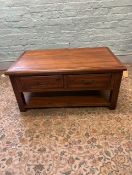 A mahogany reproduction coffee table with 1 large double sided drawer with lower storage shelf.