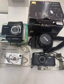 A group of 4 cameras, including the Samsung Pl100 Camera in its original box with accessories, the