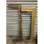 A pair of fireplace fenders, made out of wood with brass covering with ornate decoration. Courier/