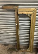 A pair of fireplace fenders, made out of wood with brass covering with ornate decoration. Courier/