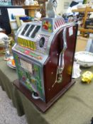 A Mills Poinsettia slot machine, one-arm bandit, c.1928, working on a 1D coin, wooden case with cast