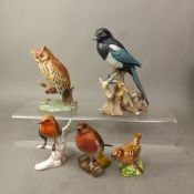 Ceramic bird figures to include a Goebel Robin, Beswick Robin and Wren and two Continental figures