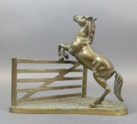 Mid 20th century heavy brass ornament of a horse jumping a five bar gate. (H: 24.5cm)