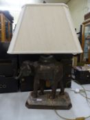 Substantial and heavy modern table lamp in the form of a bronze elephant raised on a stone and