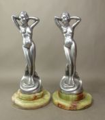 Pair of white metal Art Nouveau style figures of a naked lady, mounted on stepped green onyx
