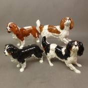 Four Beswick Cavalier King Charles models in different colourways (4)