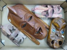 Group of four carved wooden tribal wall masks/plaques (1 tray).