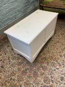A white raised painted white blanket box storage ottoman. 91cm W x 49cm H x 46cm D