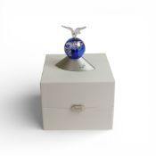 Swarovski crystal Planet was designed to celebrate the new Millennium. It comprises a blue globe