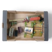 A collection of O gauge tin plate train accessories including train station, level crossings,