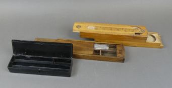 A four tier wooden pen/pencil box with original rule encorporated in the top tier, with 2 other