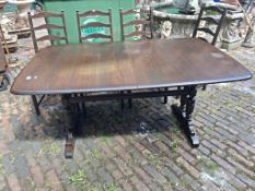 Ercol dark wood dining table, model 705, with 3 extra leaves, together with a set of 4 model 715