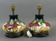 Moorcroft, a pair of table lamps in the Anna Lily pattern, by Nicola Slaney. (height to top of