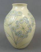 A Moorcroft Trial vase in the Cowslip design, by Nicola Slaney, white flowers against a cream