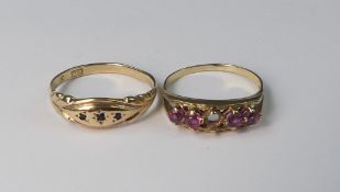 Two yellow metal rings, each set with semi precious stones , one red stone missing,electronically