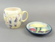 Two moorcroft pieces to include a barrel shaped mug in a Harebell design, based on the earlier