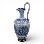 A Doulton Lambeth ewer by George Tinworth, decorated in typical colours with a scrolling design,