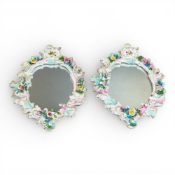 Two German porcelain wall mirrors by Schierholz & Sons, featuring ornate Rococo-style decorative