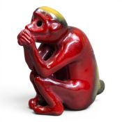 Bernard Moore Flambe seated monkey, decorated with red, yellow & green glazes, BM initialled to