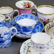 A collection of 19th century porcelain tea cups, coffee cans, saucers and a milk jug, in various