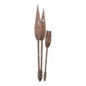 African tribal ceremonial paddles, hand-carved from wood, featuring distinctive leaf shaped blades