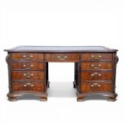 19th century mahogany serpentine fronted nine drawer desk with carved freeze and ends with brass