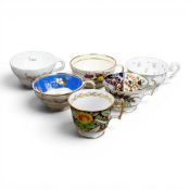 A collection of 19th century porcelain tea cups in various patterns from different manufacturers