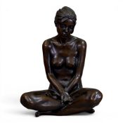 A bronze sculpture of a seated nude woman with arms crossed, signed M Turner, 3/25, h.28cm.