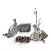 Four hallmarked silver brooches, gross weight 38.5g.
