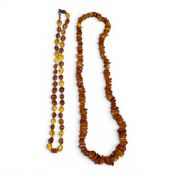 Two amber necklaces, larger one with various shaped beads, 69g and a smaller one with white metal