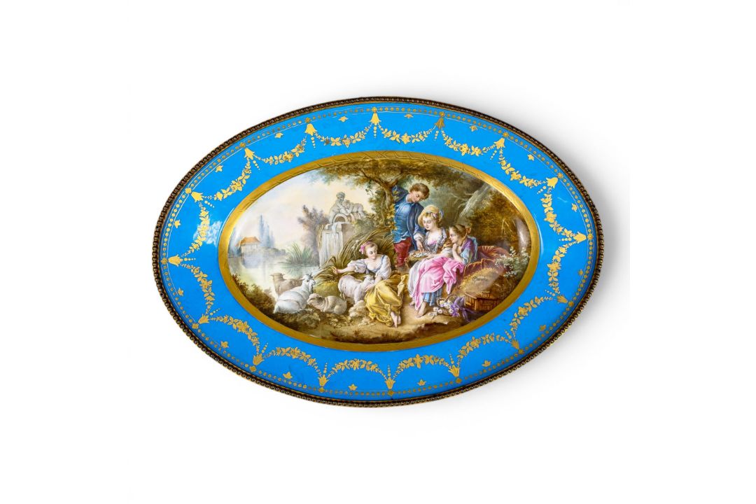 A large oval dish ornately decorated in the manner of Sevres porcelain, featuring a male and three - Image 1 of 9
