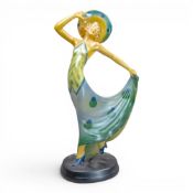 Art Deco style chalkware figurine depicting a stylised lady in a flowing green and blue spotted