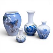 Royal Copenhagen porcelain vases of various sizes, hand-painted with butterfly and wildflowers,