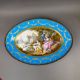 A large oval dish ornately decorated in the manner of Sevres porcelain, featuring a male and three - Image 2 of 9